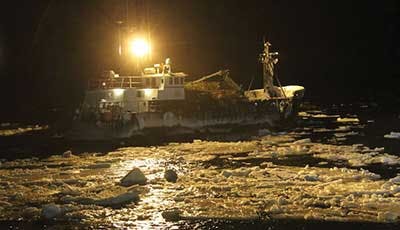 The Kodiak battles huge waves while trying to shift its crab pots to give the boat more stability in rough seas.