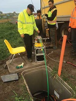 Technician blowing fiber optic cable. Technician blowing fiber optic cable.