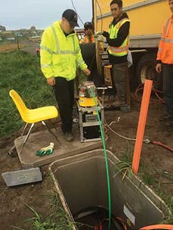 Technician blowing fiber optic cable. Technician blowing fiber optic cable.