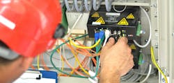 Engineer Connecting Fiber Optic Cable to the Switch
