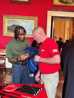 Jeremy demonstrates how to properly handle, splice, and test fiber strands to attendees of the Talent Pipeline Challenge Expo hosted at the White House on November 2, 2022. Jeremy demonstrates how to properly handle, splice, and test fiber strands to attendees of the Talent Pipeline Challenge Expo hosted at the White House on November 2, 2022.