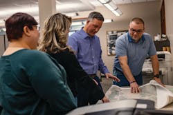 Joe, Amber Boone, Geographic Information System (GIS) Mapping Supervisor, Rick Fitchhorn, Sr., Manager of GIS Mapping, and Tracy Miller, Records Manager, collaborating.