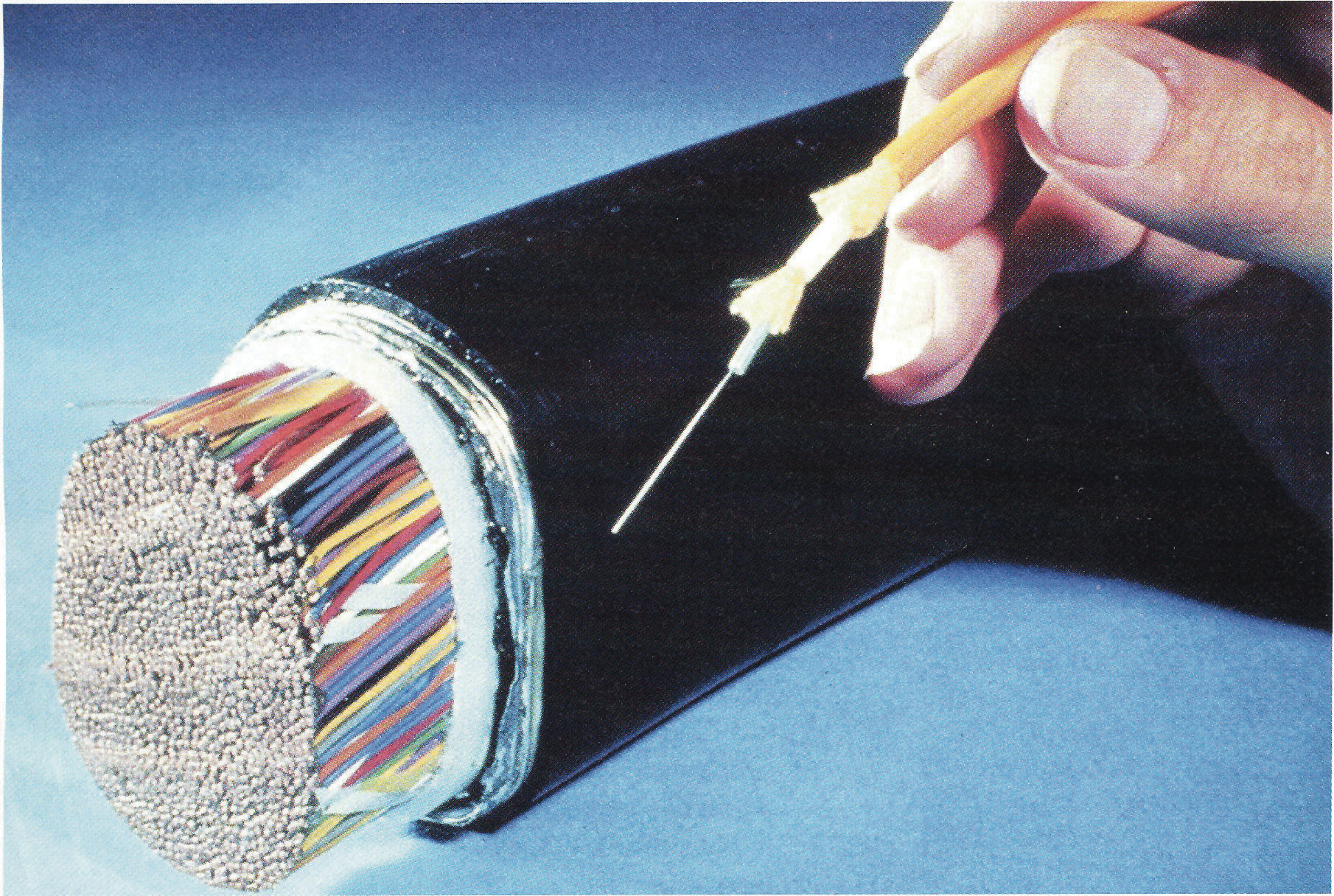 Figure 1. PR photo from the 1970s showing the advantage in size of optical fiber cables.