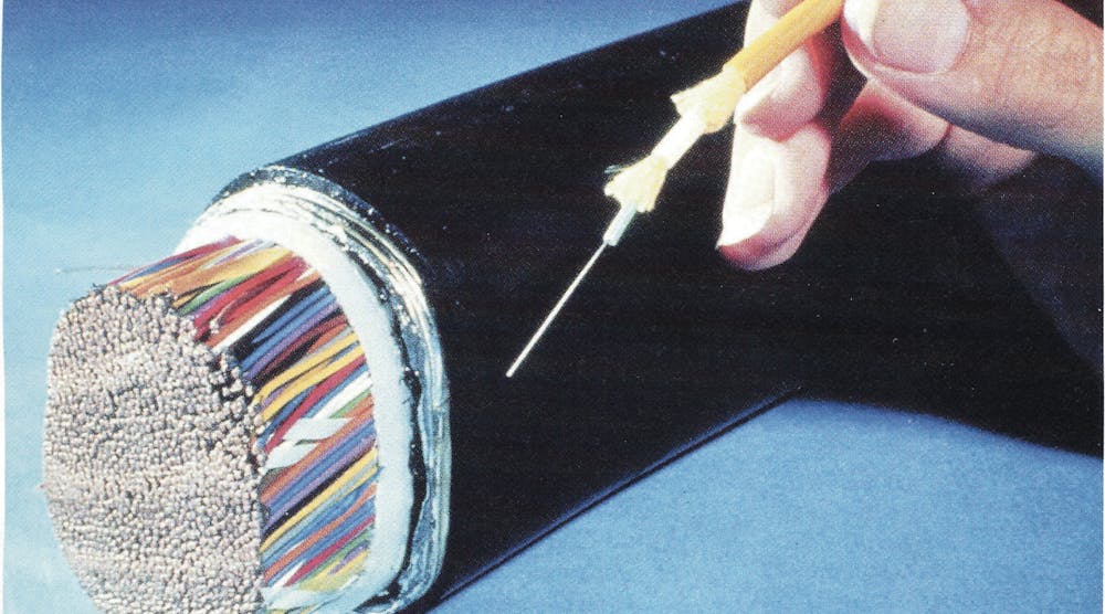 Figure 1. PR photo from the 1970s showing the advantage in size of optical fiber cables.