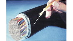 Figure 1. PR photo from the 1970s showing the advantage in size of optical fiber cables.
