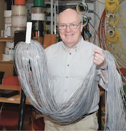 Figure 3. FOA instructor, Ian Gordon Fudge, shows a class at a data center what a 1728 fiber cable looks like before beginning his splicing lab.
