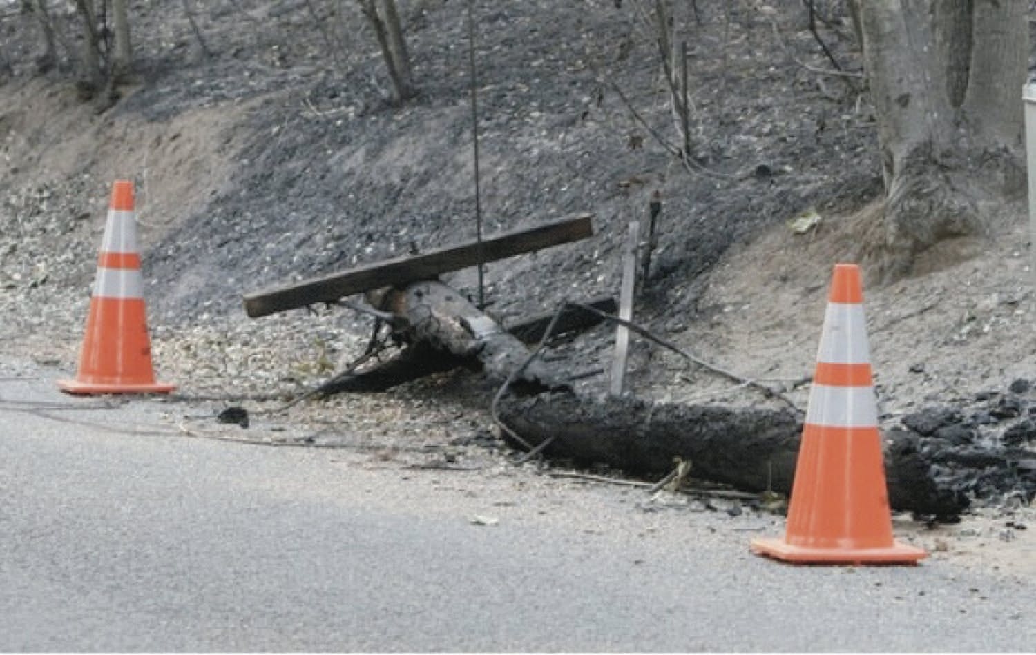 A wooden utility pole after a wildfire.