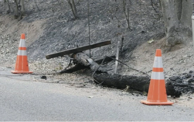 A wooden utility pole after a wildfire.