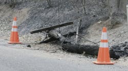 A wooden utility pole after a wildfire. A wooden utility pole after a wildfire.