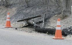 A wooden utility pole after a wildfire. A wooden utility pole after a wildfire.