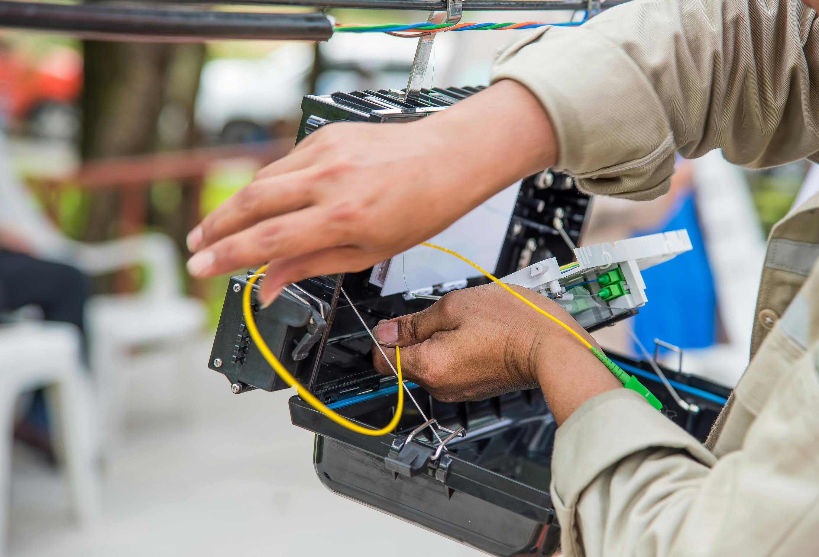 Technician Installing Cabinet On Fiber Optic Cable