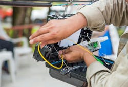 Technician Installing Cabinet On Fiber Optic Cable Technician Installing Cabinet On Fiber Optic Cable