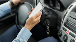Close Up Of Man Hand With Smartphone Driving Car