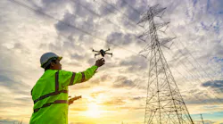 Engineers Are Launching Drones To Inspect The Power Station For A Planned Work By Generating Electricity From A High Voltage Transmission Tower At Sunset