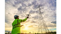 Engineers are launching drones to inspect the power station for a planned work by generating electricity from a high-voltage transmission tower at sunset. Engineers are launching drones to inspect the power station for a planned work by generating electricity from a high-voltage transmission tower at sunset.