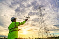 Engineers Are Launching Drones To Inspect The Power Station For A Planned Work By Generating Electricity From A High Voltage Transmission Tower At Sunset Engineers Are Launching Drones To Inspect The Power Station For A Planned Work By Generating Electricity From A High Voltage Transmission Tower At Sunset