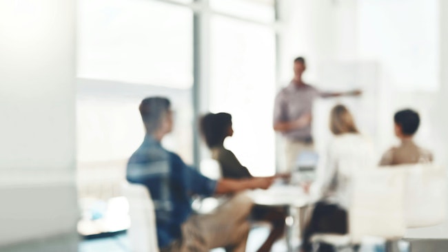 Sem-obscured image of team memebers in a meeting.