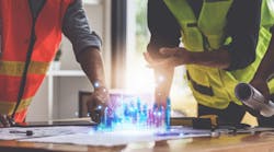 Designers and Engineers working with bluepirints Designers and Engineers working with bluepirints