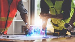 Designers and Engineers working with bluepirints Designers and Engineers working with bluepirints